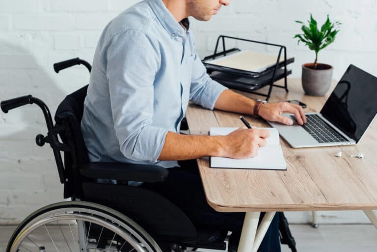 Man in wheelchair researching ERISA LTD offset by SSDI; concept of SSDI approval impact on ERISA long-term disability.