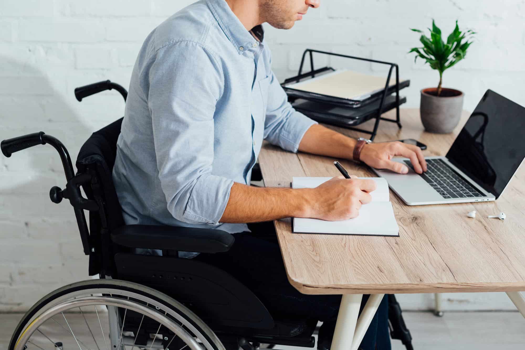 Man in wheelchair researching ERISA LTD offset by SSDI; concept of SSDI approval impact on ERISA long-term disability.